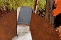 Old rusty saw blade mounted on an orange tractor front