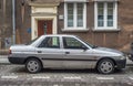 Old rusty scrap car Ford Escort parked