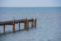 Old rusty sea berth for boats with pipes Royalty Free Stock Photo