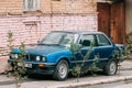 Old rusty sedan car BMW 3 Series (E30) parking on street. The BMW E30 is an entry-level luxury car which was produced by Royalty Free Stock Photo