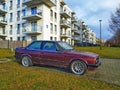 Old rusty sedan purple red BMW 318 parked Royalty Free Stock Photo