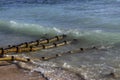 Old rusty sewer pipes in a beach. Royalty Free Stock Photo