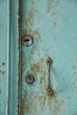 Old rusty shabby metal green door with metal handle and door latch Royalty Free Stock Photo