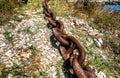 Old rusty ship anchor metal chain laying on the ground. Royalty Free Stock Photo