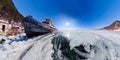 Old rusty ship on the coast of Lake Baikal among ice. Wide Panorama fisheye distortion Royalty Free Stock Photo