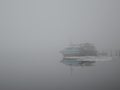 Old rusty ship in fog and snow melts around in march Royalty Free Stock Photo