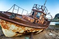 Old rusty ship, standing on a sandy beach, blue sky, beautiful n