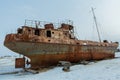 Old rusty ship on winter shore of Lake Baikal. Royalty Free Stock Photo