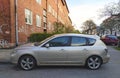 Old rusty silver Mazxda 3 first version four doors parked