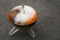 Old rusty small barbeque cooker in a garden. Cheap metal cooking device. Worn out budget way to cook food Royalty Free Stock Photo