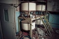 Old rusty small vats in abandoned chemical factory