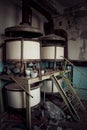 Old rusty small vats in abandoned chemical factory