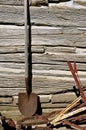 Old rusty spade rests against a log cabin wall Royalty Free Stock Photo