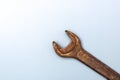 Old rusty spanner on clean grey background with copy space Royalty Free Stock Photo