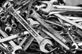 Rusty spanners and wrenches in a large pile in a toolbox