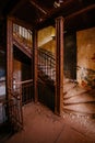 Old rusty staircase at the old ruined abandoned mansion