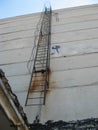 old rusty staircase to the roof of the building. Abandoned indus