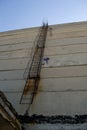 old rusty staircase to the roof of the building. Abandoned industrial object. Royalty Free Stock Photo