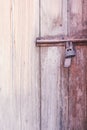 Old rusty steel latch with locked on wood door Royalty Free Stock Photo