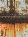 Rust metal texture with rivets, abstract grunge background Royalty Free Stock Photo