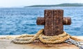 Old rusty steel mooring bollard pole on a pier. Royalty Free Stock Photo