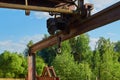 An old rusty structure with a winch and a hook