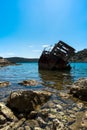 Old rusty sunken boat in blue water