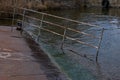 Old rusty sunken pier in the water on the territory of the river port. Royalty Free Stock Photo