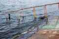 Old rusty sunken pier in the water on the territory of the river port. Royalty Free Stock Photo