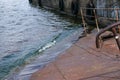 Old rusty sunken pier in the water on the territory of the river port. Royalty Free Stock Photo