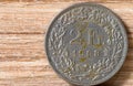 Old rusty Swiss coin on a wooden surface Royalty Free Stock Photo