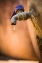 Old rusty tap leaking water. Royalty Free Stock Photo