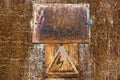 Old rusty tin surface with warning sign of high voltage Royalty Free Stock Photo