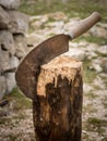 Old rusty tool for cutting wood sticking in a piece of wood Royalty Free Stock Photo