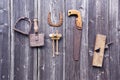 Old rusty tools hanging on grey wooden wall Royalty Free Stock Photo