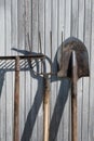 The old rusty tools, implements or household equipment on wooden background.