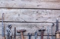 Old, rusty tools lying on a black wooden table. Hammer, chisel, hacksaw, metal wrench.Copy space Royalty Free Stock Photo