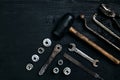 Old, rusty tools lying on a black wooden table. Hammer, chisel, metal scissors, wrench. Royalty Free Stock Photo