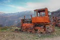 Old rusty tractor on the background of mountains Royalty Free Stock Photo