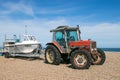 A 3085 massey ferguson pulling a speed boat on a pebble boat