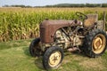 Old and rusty tractor on a corn field Royalty Free Stock Photo