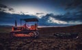 Old rusty tractor in a field on sunset.HDR image Royalty Free Stock Photo