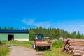 Old rusty tractor with firewood in the barn Royalty Free Stock Photo