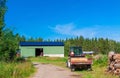 Old rusty tractor with firewood in the barn Royalty Free Stock Photo