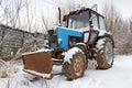 Old rusty tractor on a snowy ground Royalty Free Stock Photo