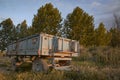 Old rusty tractor trailer abandoned in the field