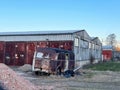 Old rusty trailer and rusty buidings