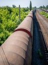 Old and rusty train wagons in the station. Long freight train on the railway tracks Royalty Free Stock Photo