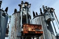 Old rusty transformer substation against the blue sky