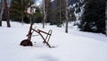 An old rusty tricycle in the winter forest